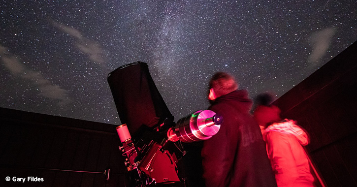 group of people using telescope at Grassholme Observatory 